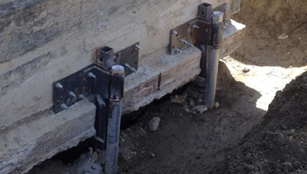 Close up view of metal posts used for foundation repair.