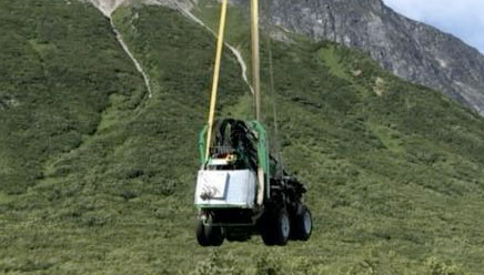 View of equipment coming into Alaska wilderness from a helicopter.